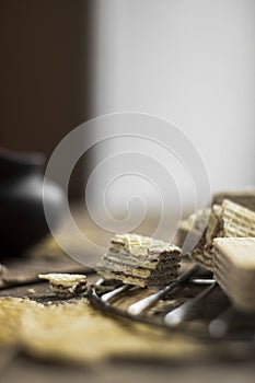 Sweet russian artek waffles on wooden background, with a pot of milk. Traditional sweets and dessert