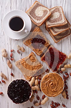 Sweet sandwiches with jelly, peanut butter and coffee top view