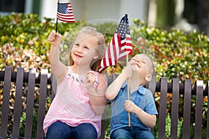 Sweet Sister and Brother Playing with American Flags