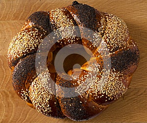 A sweet Slavic bun, made in the shape of a ring, called Kalach, on a wooden board
