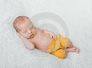 Sweet sleeping newborn boy in yellow panties