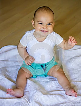 Sweet smiling baby on the floor. Baby boy at home