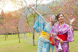 Sweet smiling women wearing traditional kimono