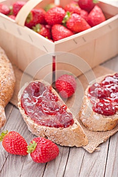 Sweet strawberries jam on bread slice.