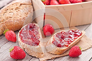 Sweet strawberries jam on bread slice.