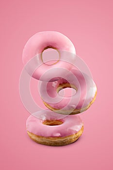 Sweet strawberry donuts isolated on a pink background