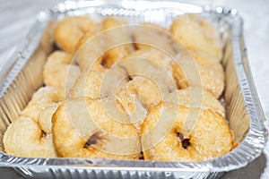 Sweet Sugar-Coated Donuts on Aluminum Foil Baking Pan.