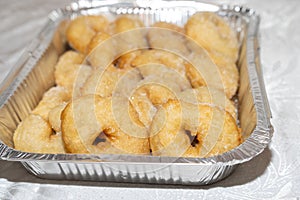 Sweet Sugar-Coated Donuts on Aluminum Foil Baking Pan.