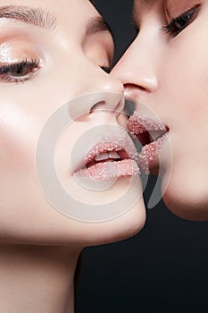 Sweet sugar kiss. two girls are kissing