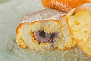 Sweet sugary donuts on rustic table