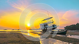 Sweet sunrise above fishing boats on the beach.