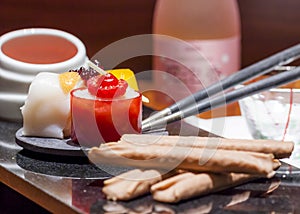 Sweet sushi art display in a luxury marble plate and a bottle of sake