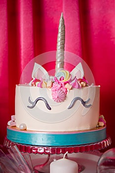 Sweet table and big unicorn cake for baby girl first birthday