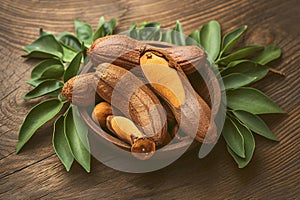 Sweet tamarind and leaves on wooden background, tropical fruit concept photo