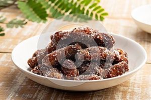 Sweet tamarind mix with sugar and chilli in white plate