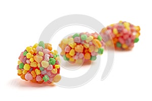 Sweet and Tangy Candy with Small Candies on the Outside of a Chewy Center Isolated on a White Background