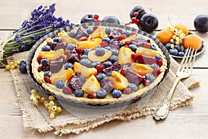 Sweet tart with peaches, plums and blueberries photo