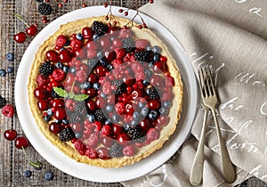 Sweet tart with raspberries, blueberries, blackberries, cherries photo