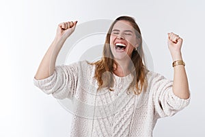 Sweet taste victory. Portrait very happy attractive celebrating young woman jumping happiness win raising clenching photo