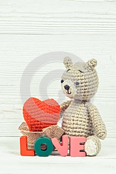 Sweet teddy bear doll with Love text and red knitting heart on