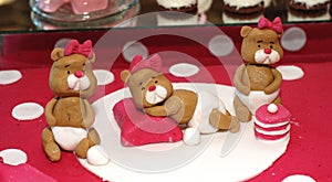 Sweet teddy bears on a birthday cake