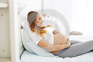 Joyful pregnant woman enjoying pregnancy