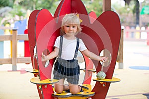 Sweet toddler child, boy, playing on the playground