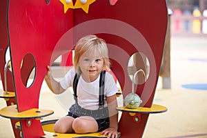 Sweet toddler child, boy, playing on the playground