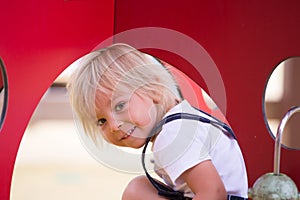 Sweet toddler child, boy, playing on the playground