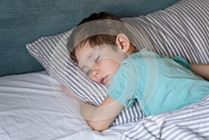 Sweet toddler child dreaming at home. Little boy sleeping.