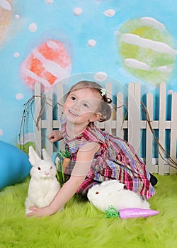Sweet toddler girl with bunny at easter