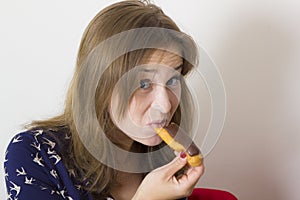 Sweet tooth girl eating eclairs photo