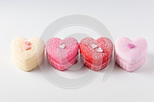 Sweet valentines day heart cakes on white background