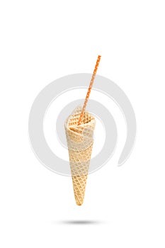 Sweet vanilla wafer cone with a drinking straw floatin on a white background