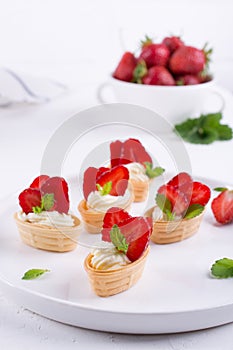 Sweet waffle basket with cream cheese and strawberries for summer breakfast