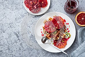 Sweet waffles with red blood oranges and pistachios nuts