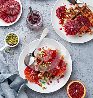 Sweet waffles with red blood oranges and pistachios nuts