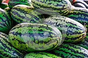 Sweet watermelon, a large number of large green organic crops on the farmers market in Thailand, Asia. Fruit for weight loss and