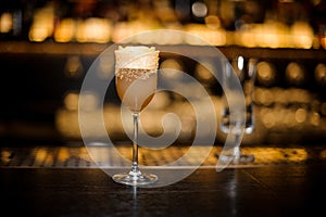 Sweet wine glass filled with delicious sour brandy crusta cocktail on the bar counter