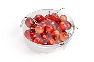 Sweet yellow cherry in glass pot, isolated on white background. Close-up