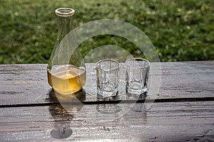 Sweet yellow honey wine meade on the wooden table. Ready to drink. photo