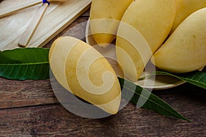 Sweet yellow mango fruit on wood table , ready to eat for healt