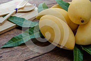 Sweet yellow mango fruit on wood table , ready to eat for healt