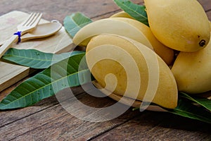 Sweet yellow mango fruit on wood table , ready to eat for healthy , fruit on summer