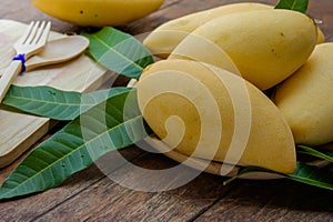 Sweet yellow mango fruit on wood table , ready to eat for healthy , fruit on summer