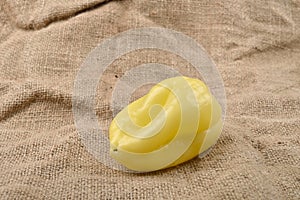 Sweet yellow pepper lying on jute canvas background. Concept of