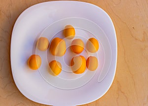 Sweet yellow tomatoes on a white plate