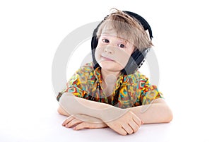 Sweet young boy listening to music on headphones