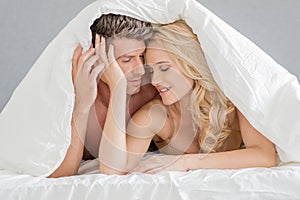 Sweet Young Couple on Bed Fashion Shoot