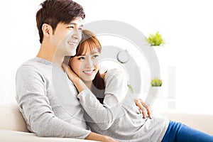 Sweet young couple sitting in sofa
